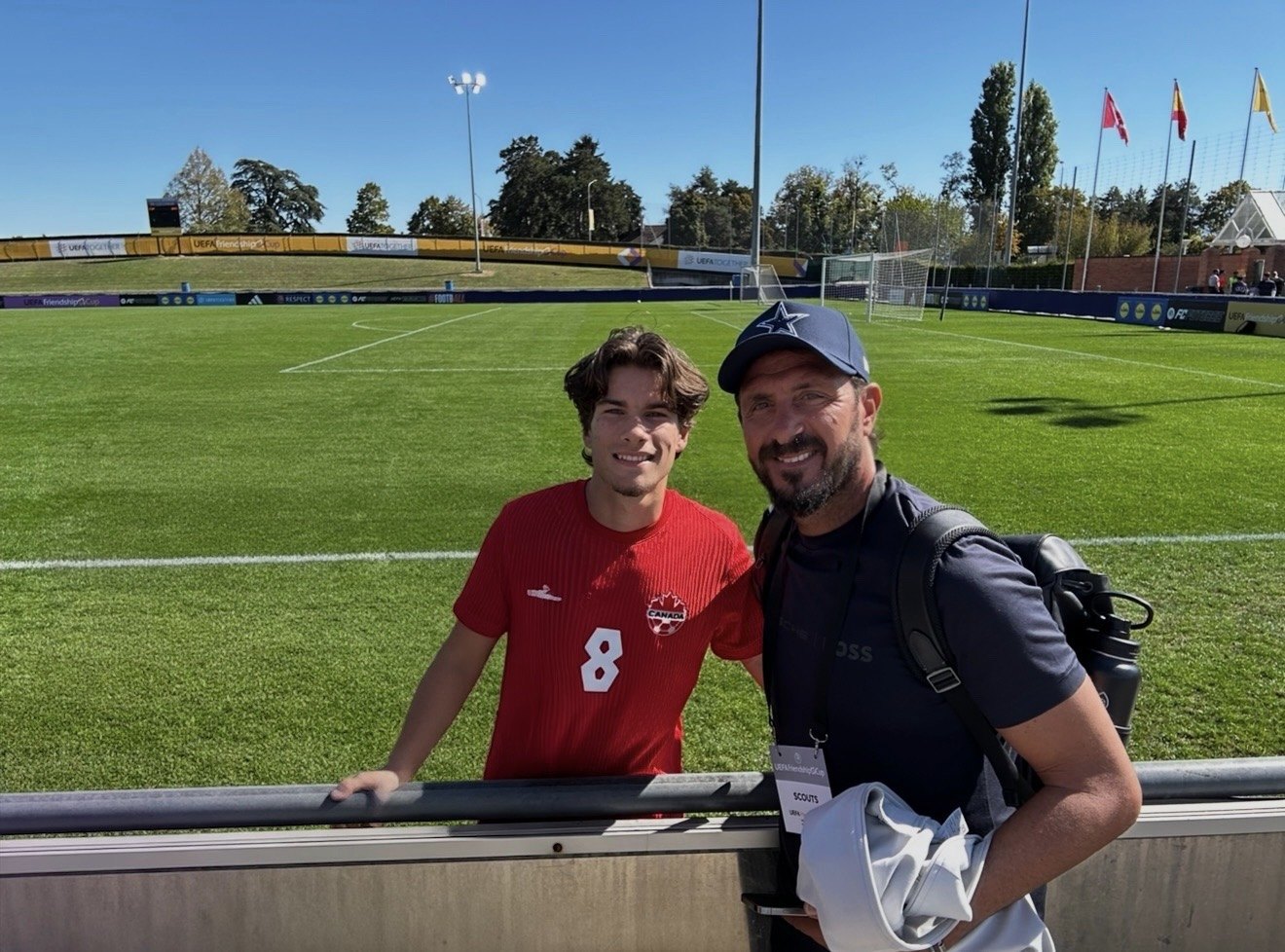 Asterios Themelis pitch-side with a Canada national team player at the UEFA Friendship Cup